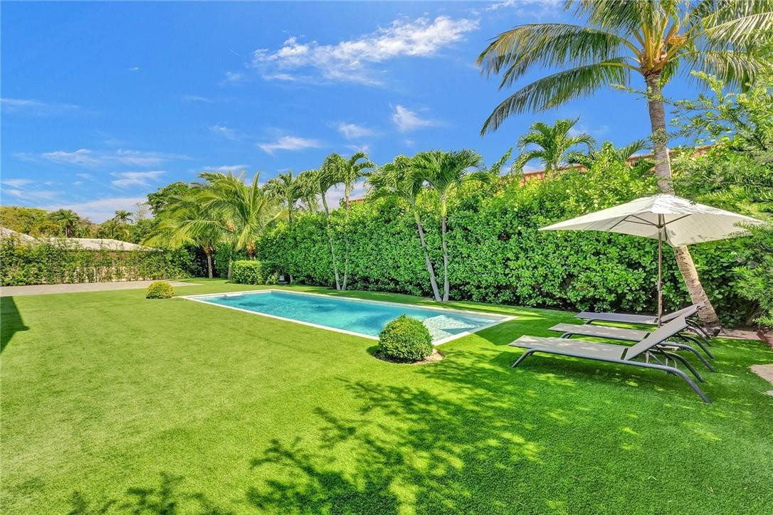 9 Tahoe Lane Sea Ranch Lakes, FL 33308 - Photo 47 of 54 a view of a house with a backyard and swimming pool
