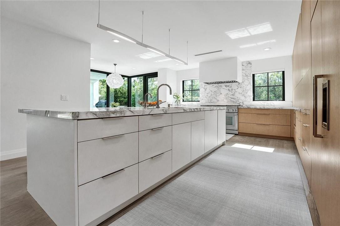 9 Tahoe Lane Sea Ranch Lakes, FL 33308 - Photo 7 of 54 a kitchen with white cabinets and a sink