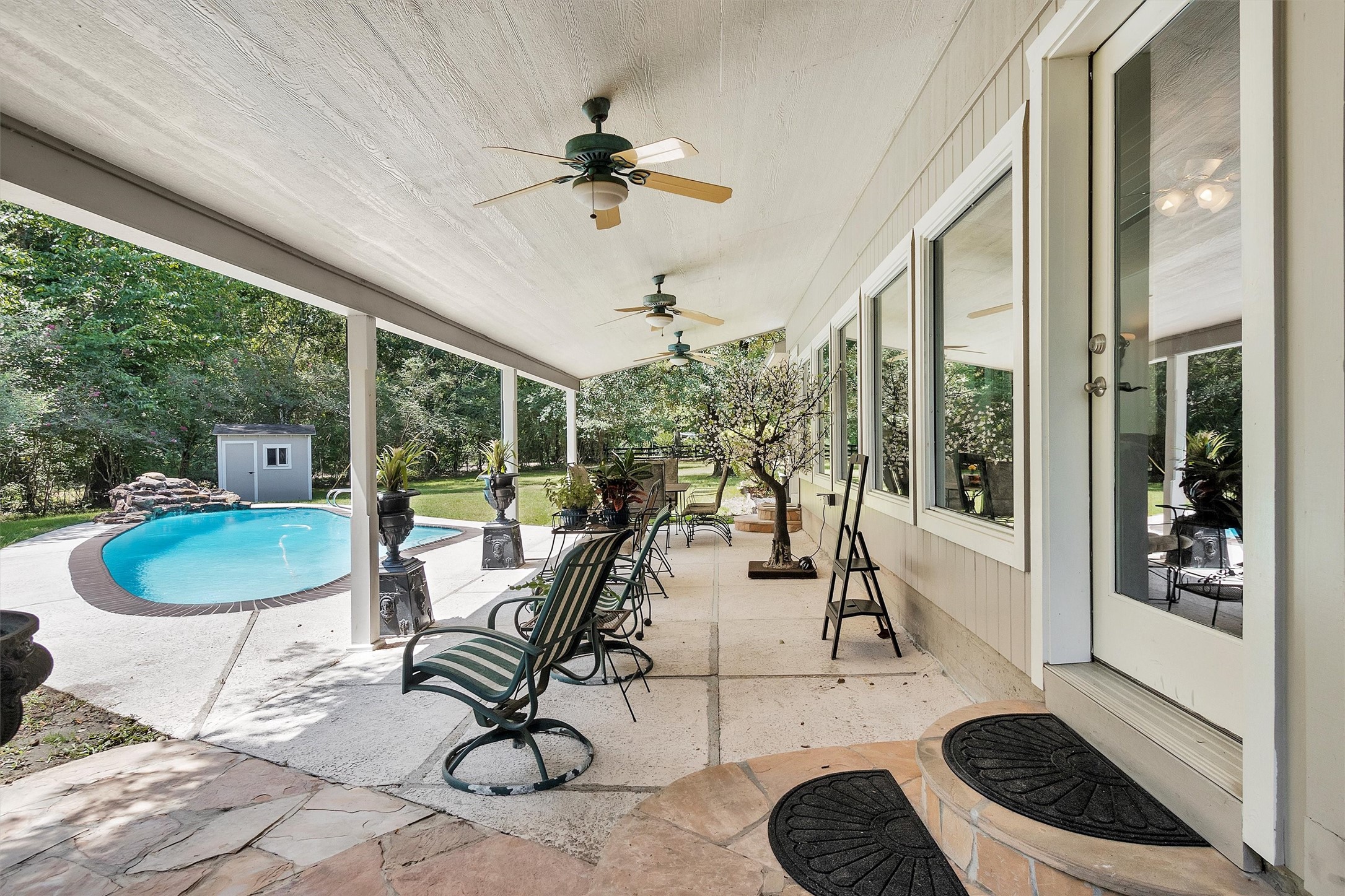 10135 Wahrenberger Road Conroe, TX 77304 - Photo 2 of 49 a view of a dining room with furniture water view and a floor to ceiling window