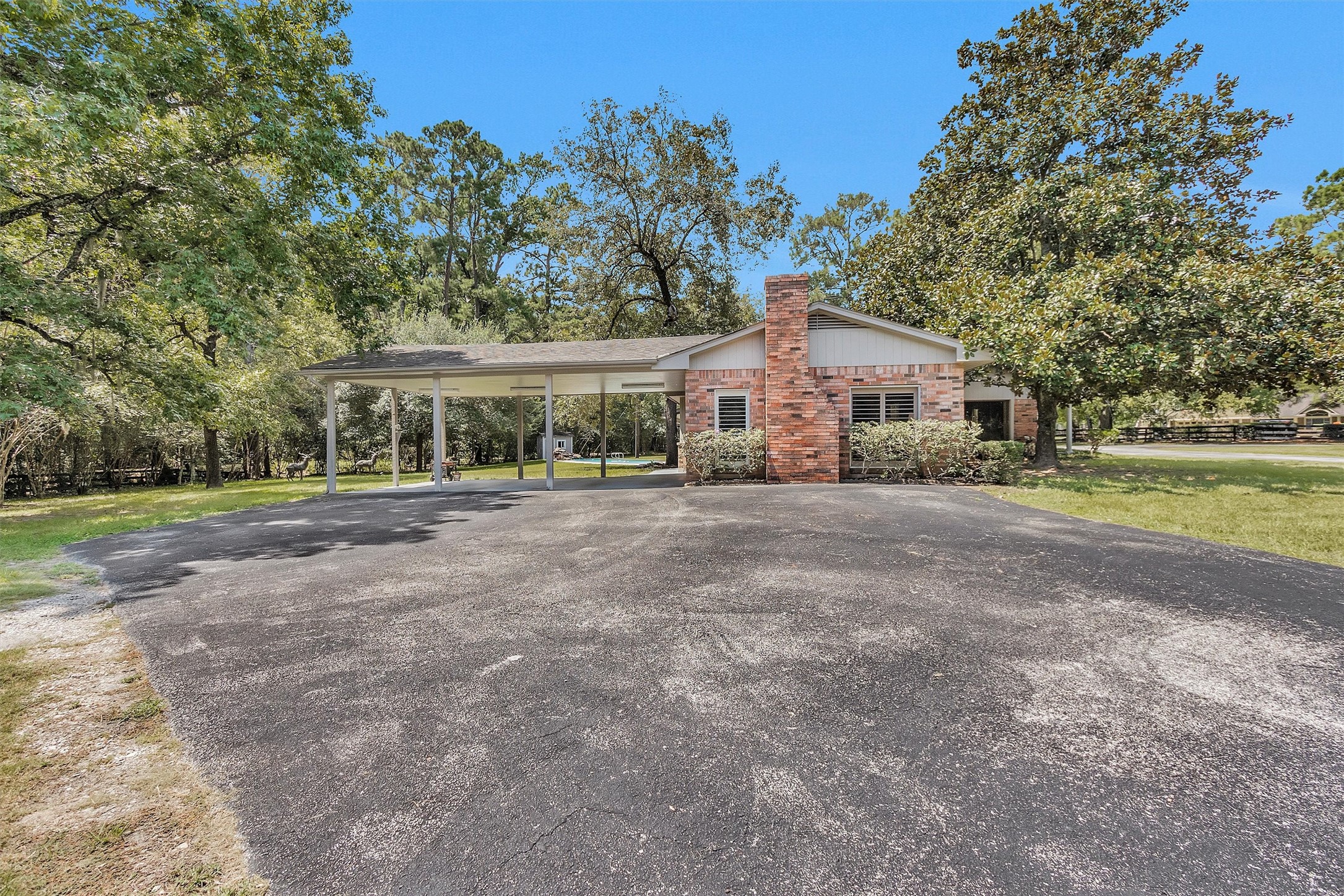 10135 Wahrenberger Road Conroe, TX 77304 - Photo 31 of 49 a view of house with a big yard and large trees
