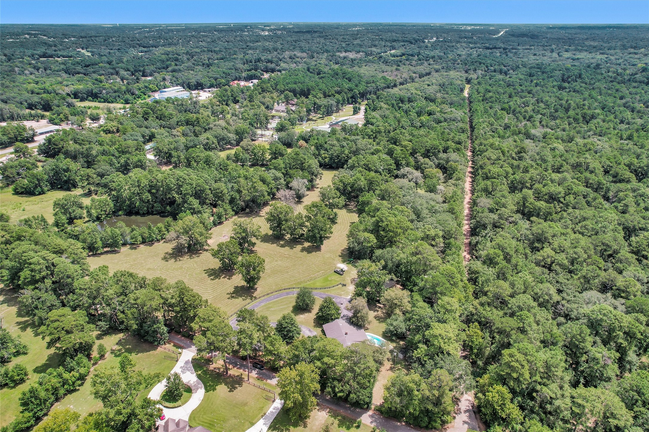 10135 Wahrenberger Road Conroe, TX 77304 - Photo 46 of 49 an aerial view of residential houses with outdoor space and trees