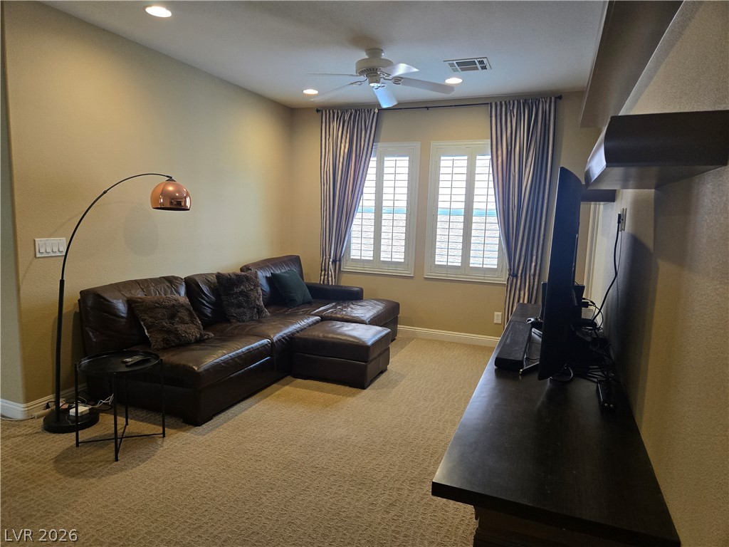 3144 Whitfeild Avenue Henderson, NV 89044 - Photo 45 of 55 A comfortable media room with textured carpet, perfect for relaxation and entertainment.