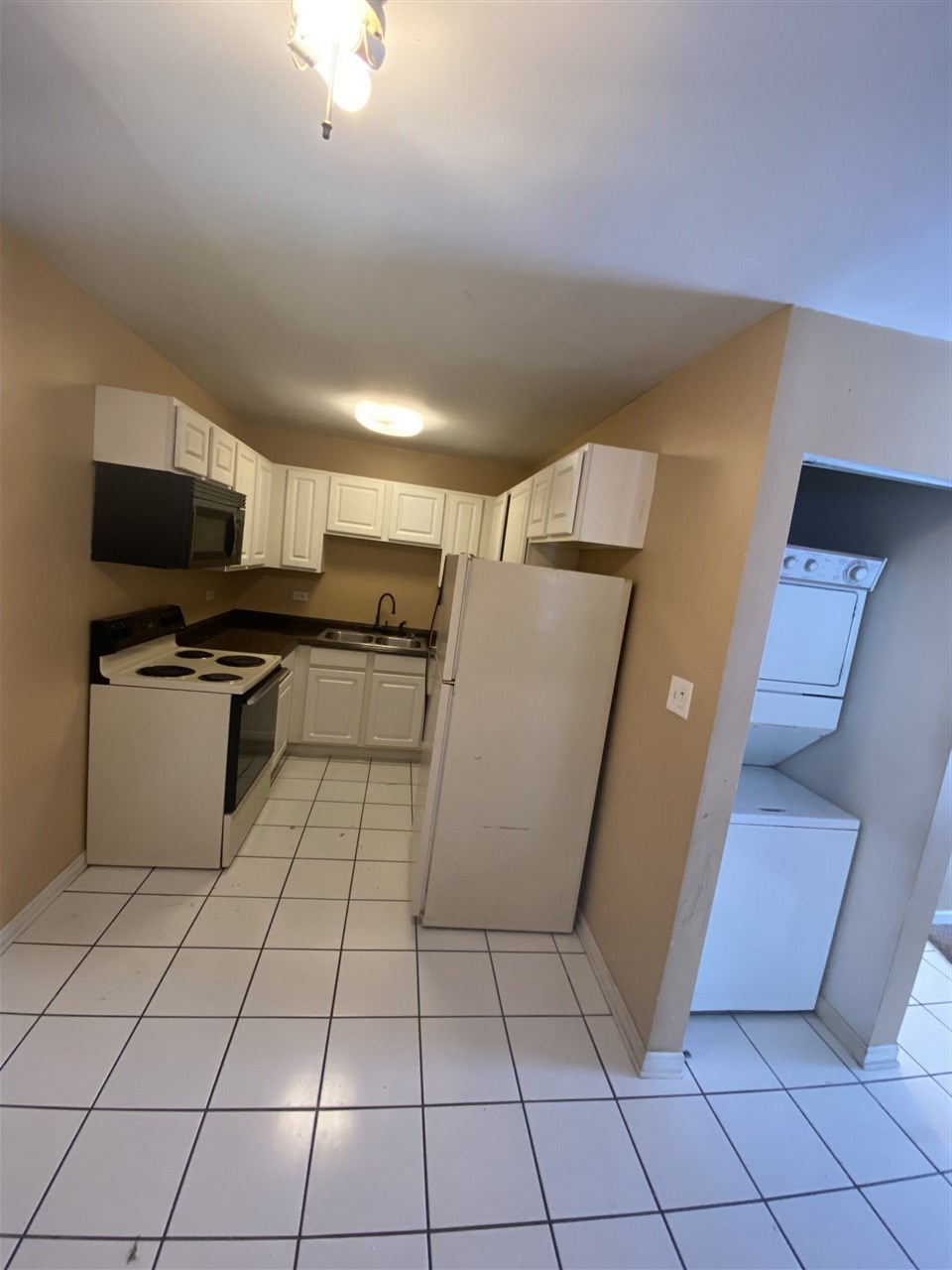 2000 Light Road Oswego, IL 60543 - Photo 11 of 16 a kitchen with a sink a microwave a counter top space and cabinets
