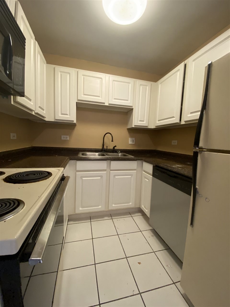 2000 Light Road Oswego, IL 60543 - Photo 12 of 16 a kitchen with a sink a stove and cabinets