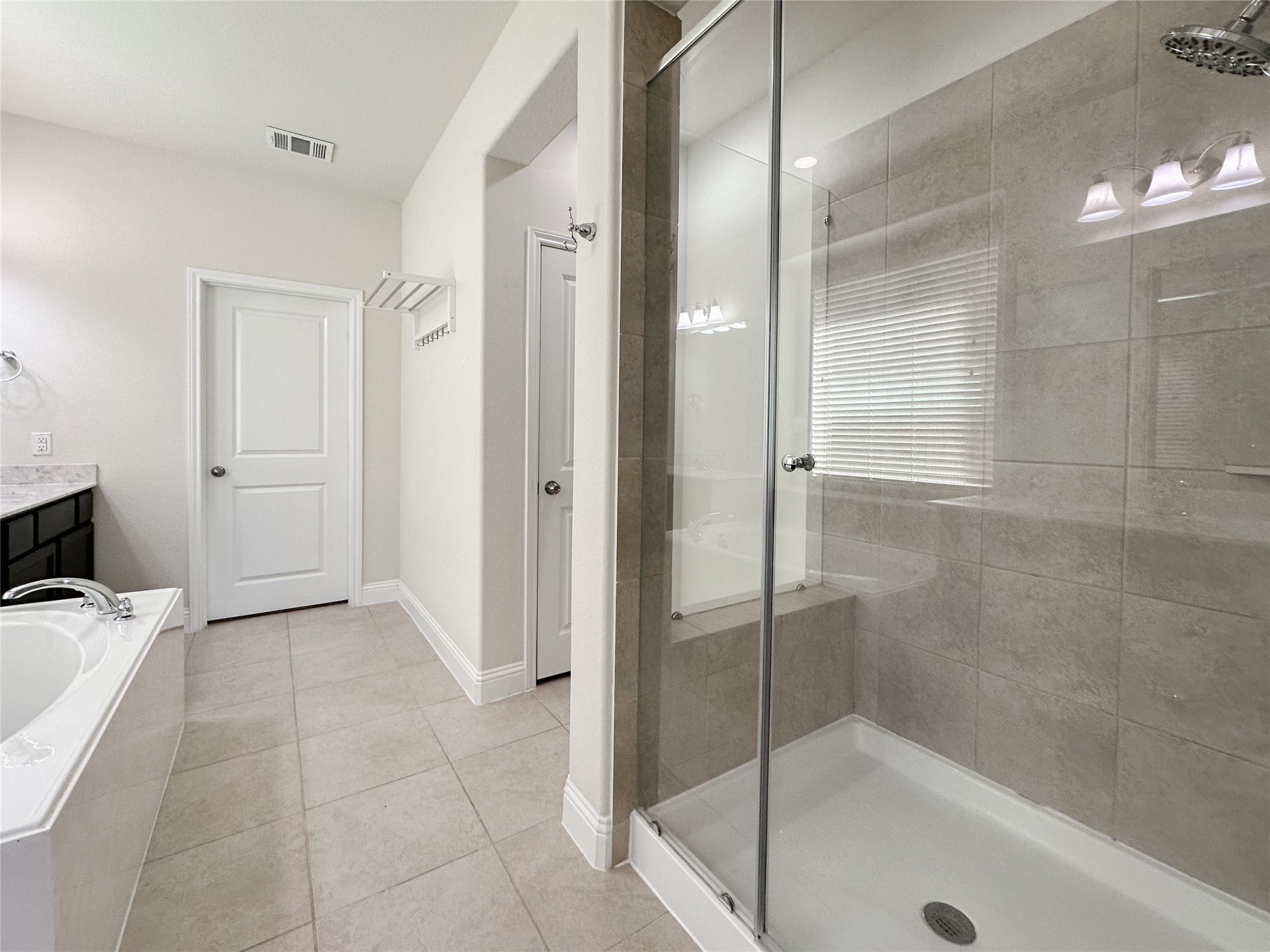 6715 Chicoma Street Spring, TX 77379 - Photo 20 of 20 a bathroom with a bathtub and a shower
