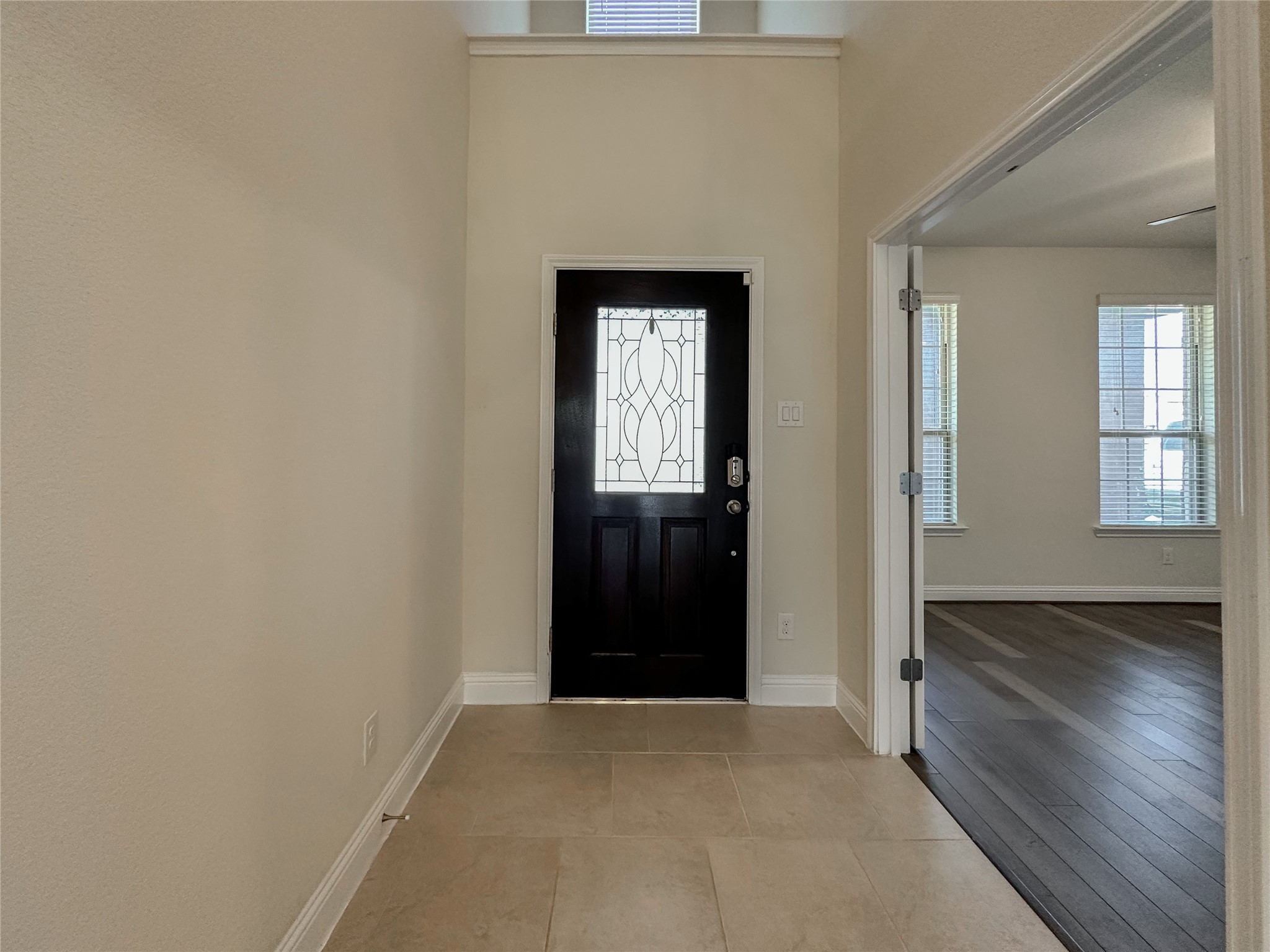 6715 Chicoma Street Spring, TX 77379 - Photo 4 of 20 a view of an empty room with wooden floor and a window