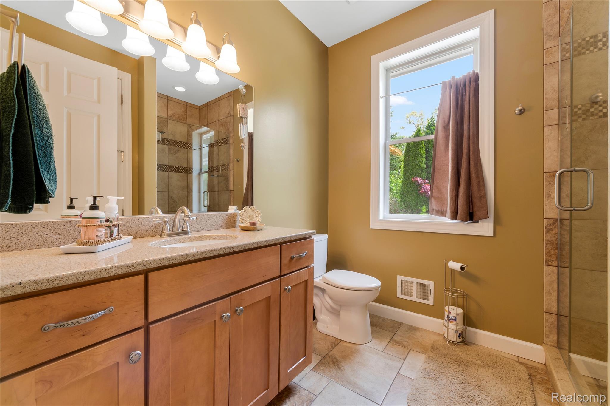 13085 Rohn Road Fenton, MI 48430 - Photo 20 of 52 Full bathroom with a shower stall, vanity, and light tile patterned flooring