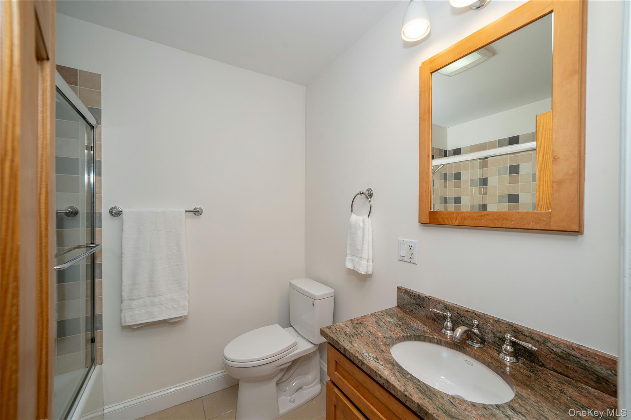 53 Tarryhill Road Tarrytown, NY 10591 - Photo 23 of 35 The full hall bath features attractive tilework in the tub/shower and a granite-topped vanity.