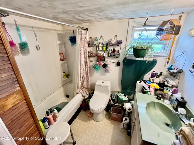 a bathroom with a sink mirror vanity and toilet