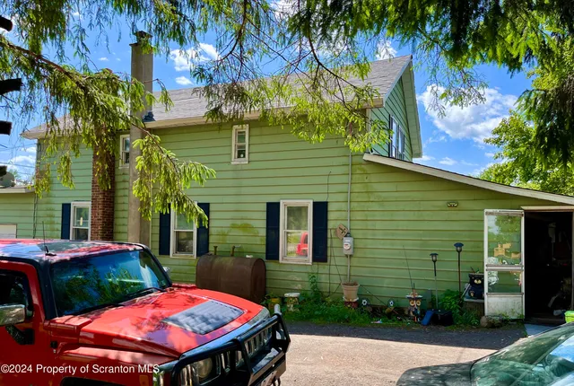 a view of a patio with table and chairs and potted plants