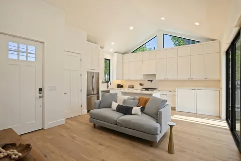 a kitchen with stainless steel appliances a refrigerator sink and cabinets