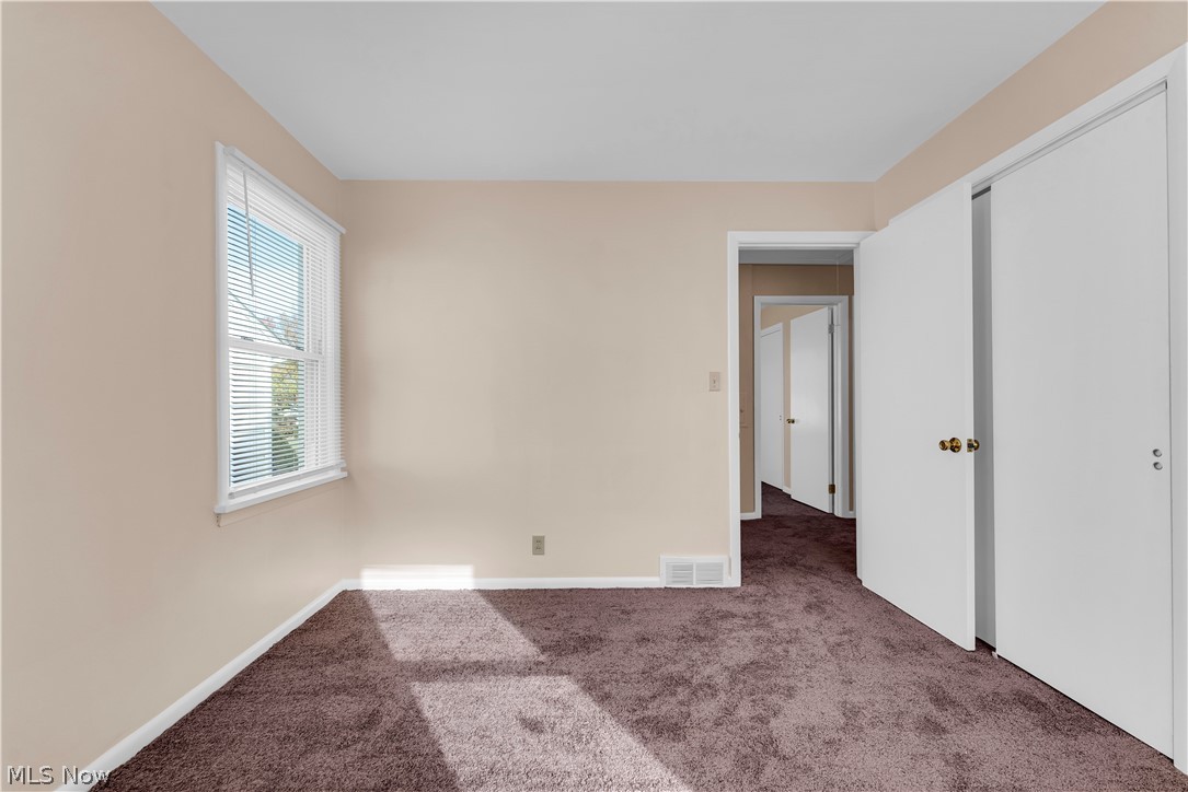 9716 Alexander Road Cleveland, OH 44125 - Photo 13 of 30 Unfurnished bedroom featuring carpet flooring and a closet