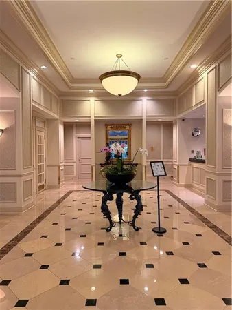 a lobby with furniture and a rug