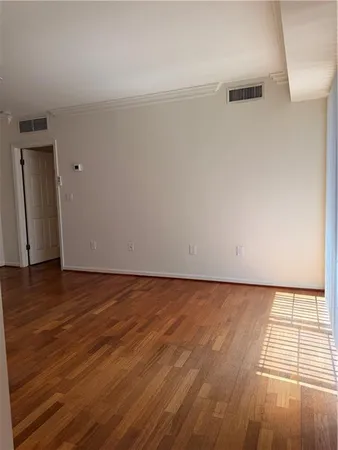 a view of an empty room and wooden floor