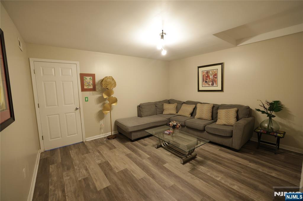 59 Spring Valley Avenue Hackensack, NJ 07601 - Photo 16 of 26 a living room with furniture and a wooden floor