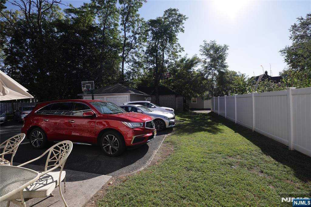 59 Spring Valley Avenue Hackensack, NJ 07601 - Photo 24 of 26 a front view of a house with a garden