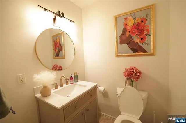 a bathroom with a toilet a sink and a mirror