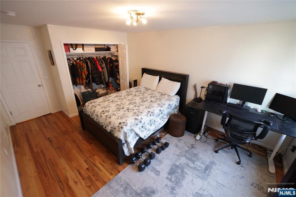 59 Spring Valley Avenue Hackensack, NJ 07601 - Photo 10 of 26 a bed room with a bed and a chair