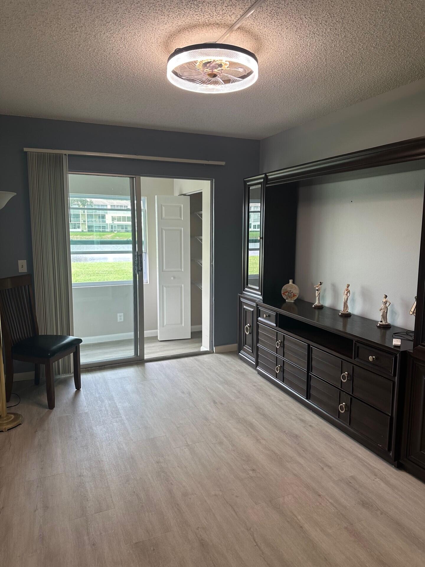 340 Mansfield Drive Boca Raton, FL 33434 - Photo 11 of 23 wooden floor in an empty room with a window