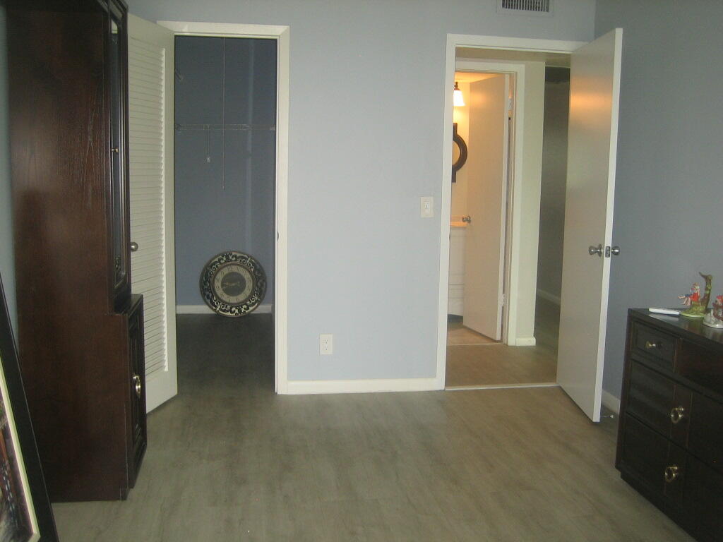 340 Mansfield Drive Boca Raton, FL 33434 - Photo 12 of 23 an empty room with closet and mirror