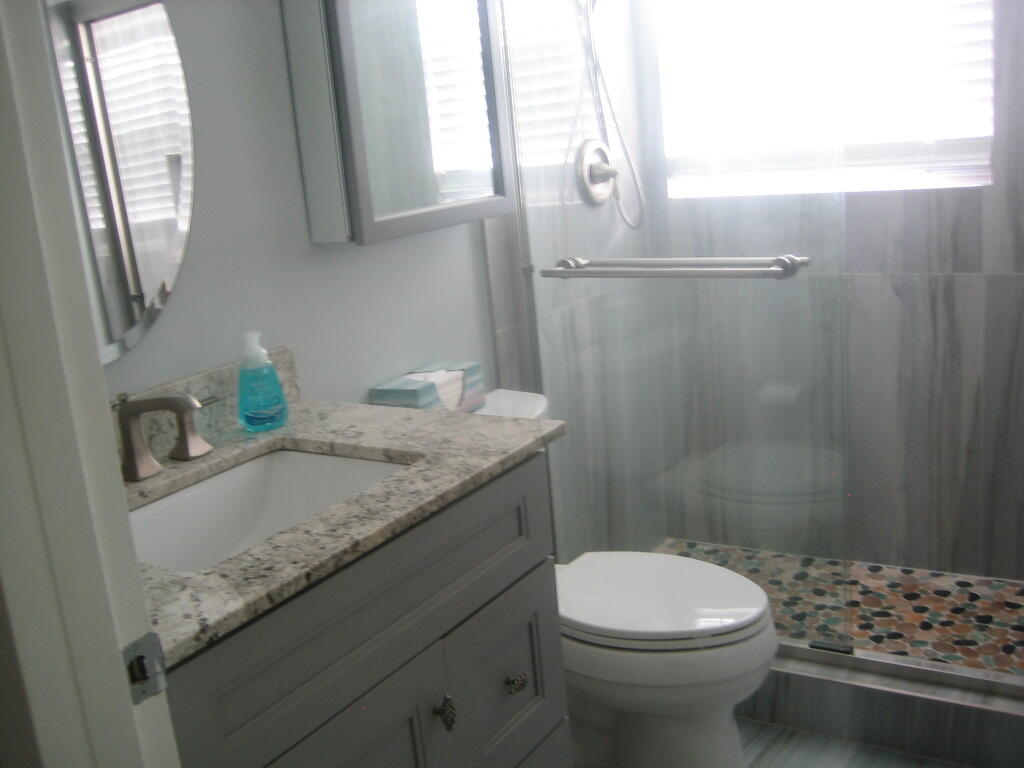 340 Mansfield Drive Boca Raton, FL 33434 - Photo 16 of 23 a bathroom with a granite countertop sink toilet and shower