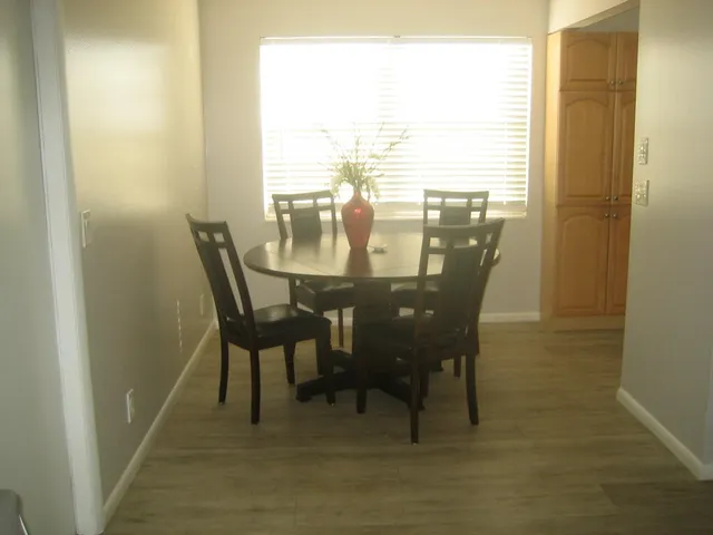 a view of a dining room with furniture and wooden floor