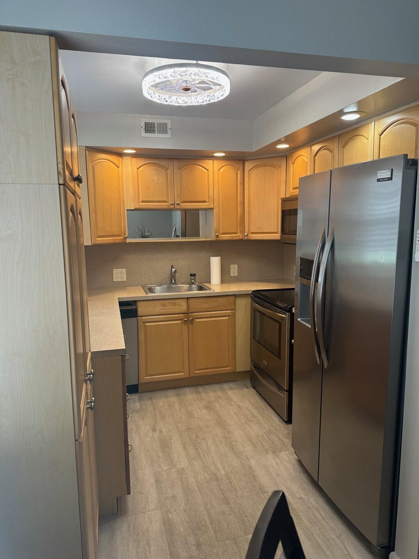 340 Mansfield Drive Boca Raton, FL 33434 - Photo 5 of 23 a kitchen with appliances cabinets and a sink