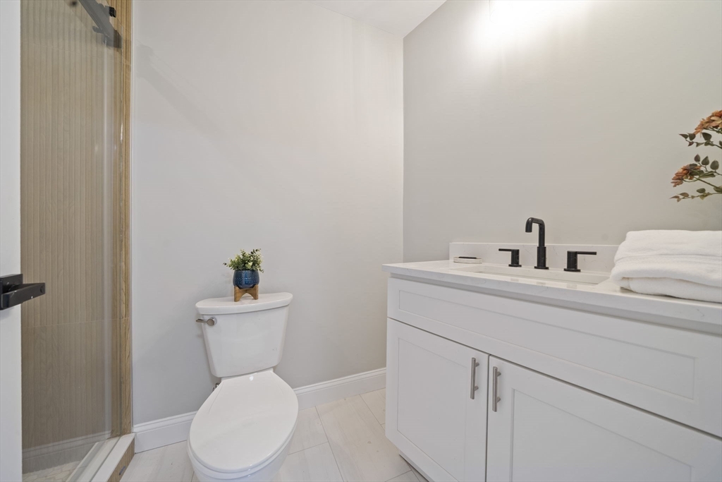 52 Bellevue Street, Unit 1 Boston, MA 02125 - Photo 11 of 16 a white toilet sitting next to a bathroom sink
