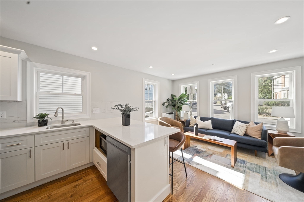 52 Bellevue Street, Unit 1 Boston, MA 02125 - Photo 5 of 16 a living room with furniture a wooden floor and sink