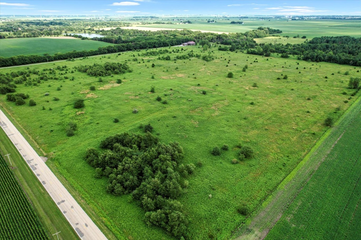 a view of a green field with lots of green space in the back