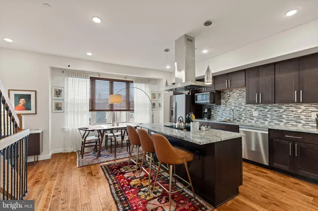 a kitchen with granite countertop a sink stove and cabinets