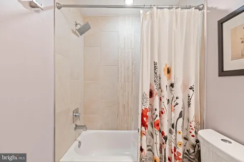 a bathroom with a shower curtain and a curtain