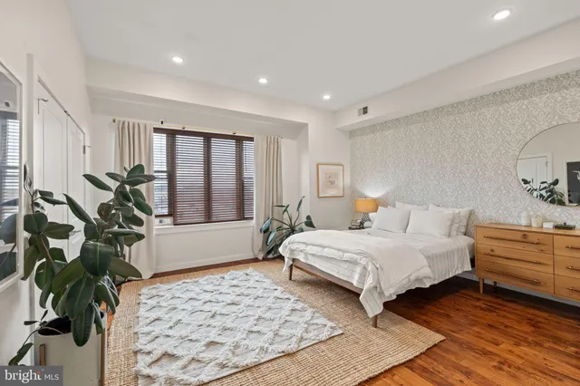 a bedroom with a large bed and a window