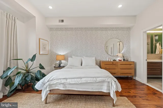 a bed room with a bed mirror and window