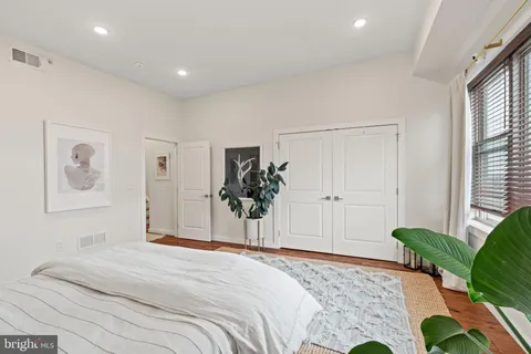 a bedroom with a bed and a window