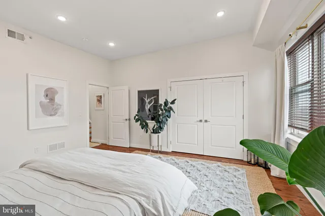 a bedroom with a bed and a window