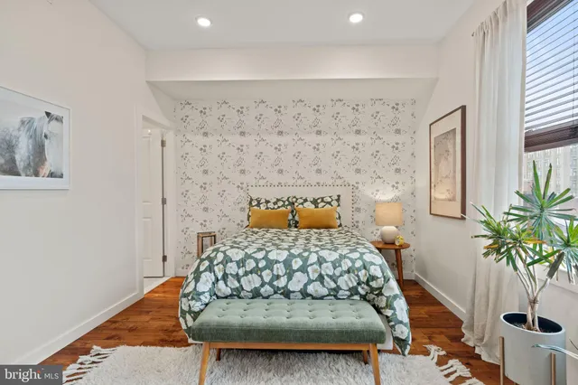 a bedroom with a bed and a potted plant