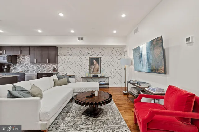 a living room with furniture and wooden floor
