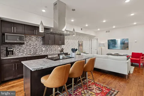 a kitchen with a table chairs sink and microwave