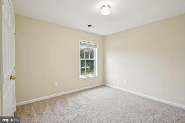 a picture of a room with a white wall and a large window