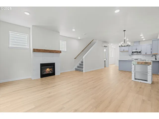 a view of kitchen and hall with wooden floor