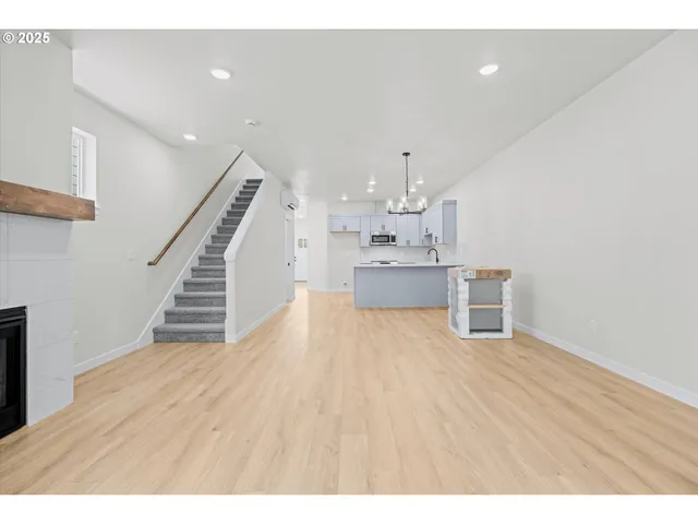 a view of kitchen and hall with wooden floor