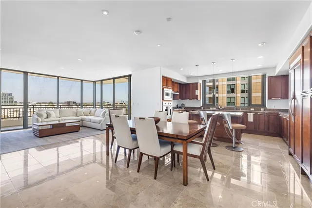 a dining room with furniture and a floor to ceiling window