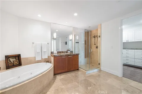 a large living room with stainless steel appliances granite countertop a sink and a refrigerator