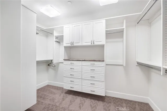 a large white bed sitting in a bedroom next to a window