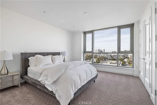 a bathroom with a granite countertop sink a large mirror and a shower