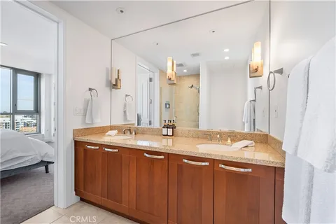 a bedroom with a bed and a mirror