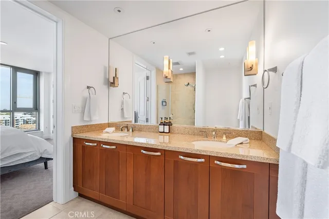 a bedroom with a bed and a mirror