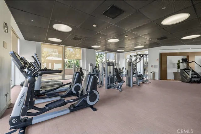 a room with furniture pool table and windows