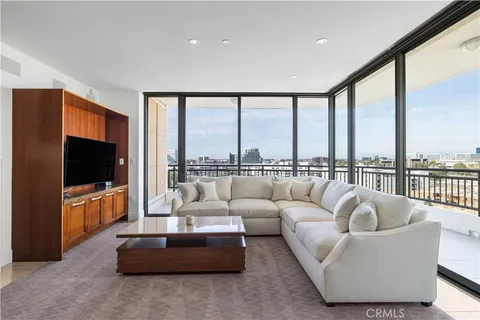 a living room with furniture a flat screen tv and a large window